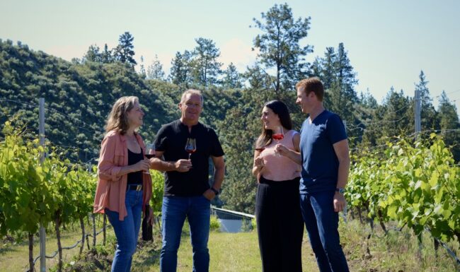 Owners of 1 Mill Road drinking wine in the vineyard