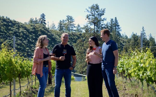 Owners of 1 Mill Road drinking wine in the vineyard